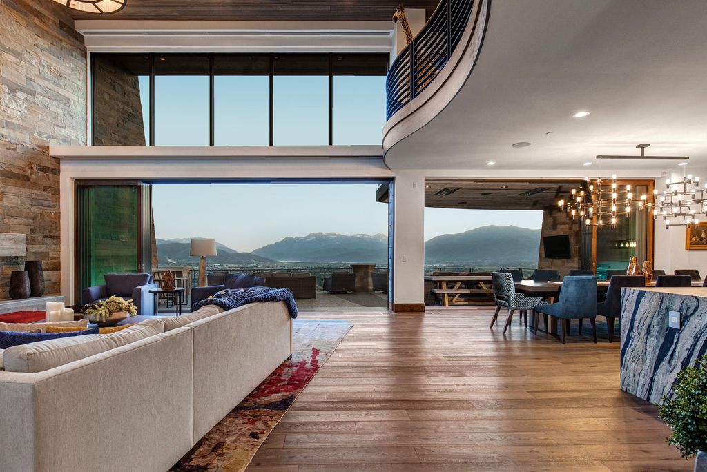 831 N Explorer Peak Drive Home in Heber, Utah. Perched atop the highest ridge within the exclusive confines of Red Ledges, this estate offers unparalleled vistas of the Mountain West. Crafted by renowned architect Michael Upwall, this residence redefines mountain modern living. 