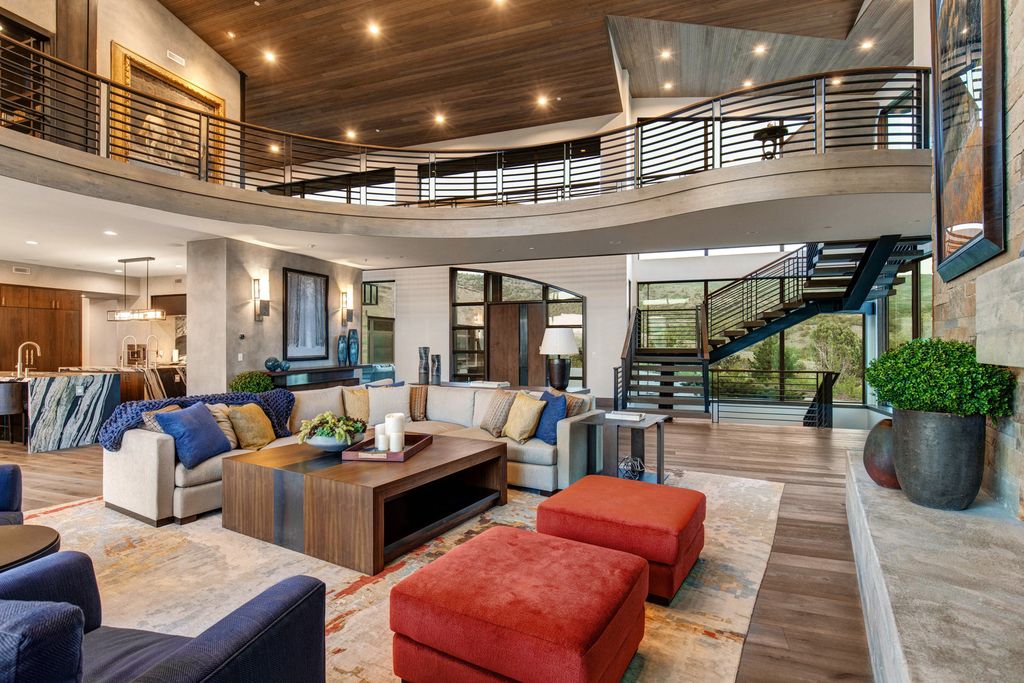 831 N Explorer Peak Drive Home in Heber, Utah. Perched atop the highest ridge within the exclusive confines of Red Ledges, this estate offers unparalleled vistas of the Mountain West. Crafted by renowned architect Michael Upwall, this residence redefines mountain modern living. 