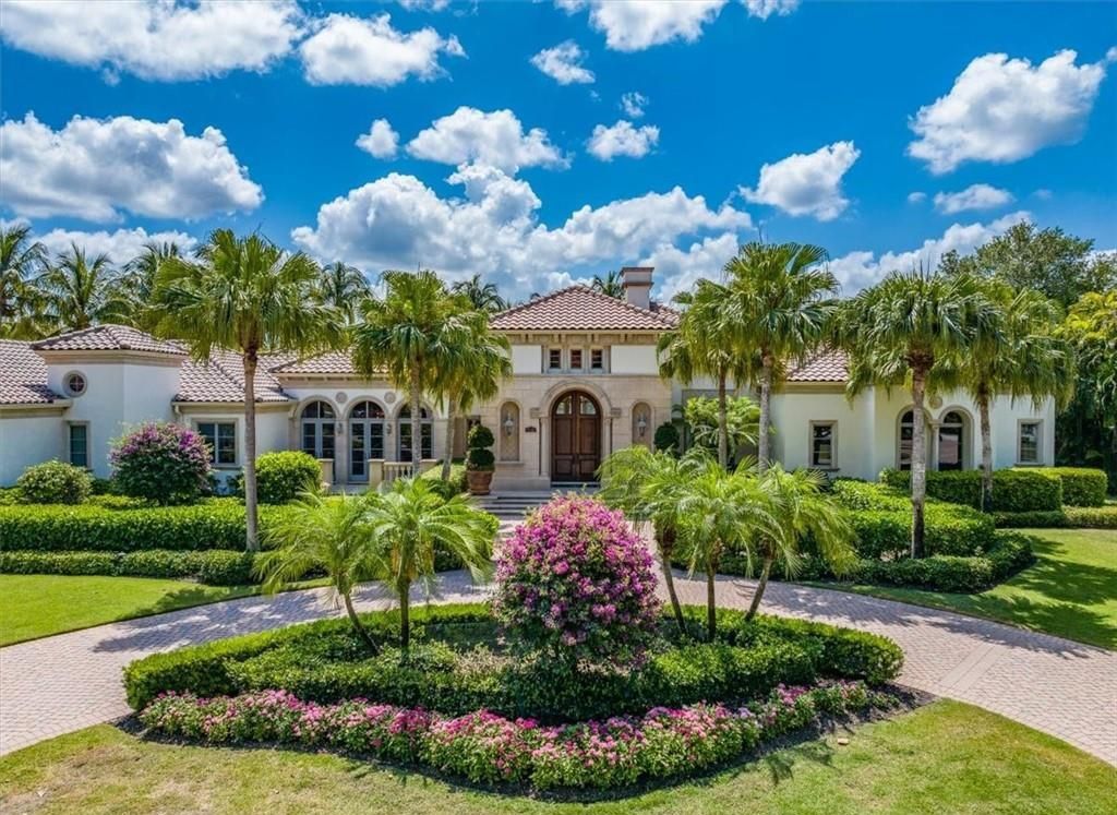 Discover an exquisite 6,500 sq ft single-level home at 2116 Canna Way, Naples, FL, set on a stunning 0.78-acre lot with picturesque lake and golf course views.