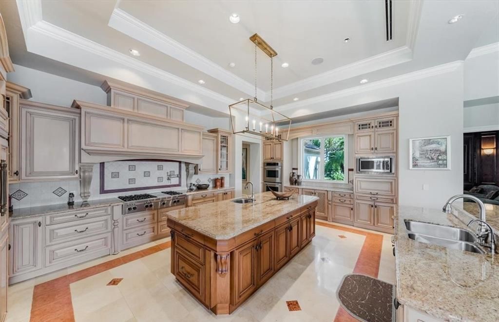 Discover an exquisite 6,500 sq ft single-level home at 2116 Canna Way, Naples, FL, set on a stunning 0.78-acre lot with picturesque lake and golf course views.