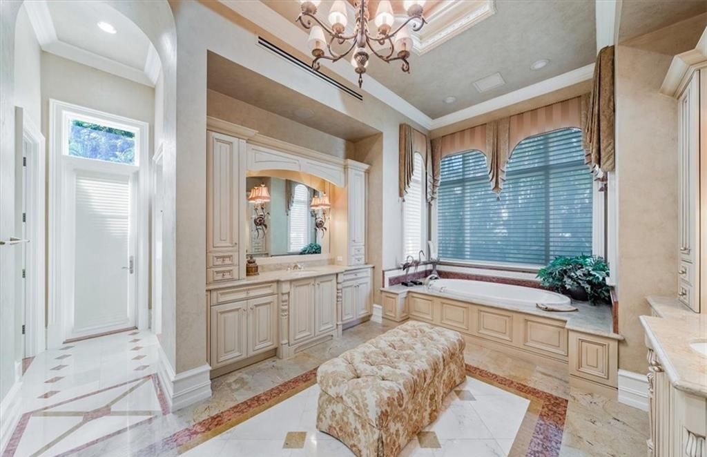 Discover an exquisite 6,500 sq ft single-level home at 2116 Canna Way, Naples, FL, set on a stunning 0.78-acre lot with picturesque lake and golf course views.