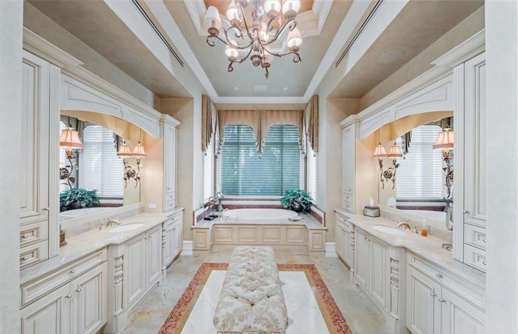 Discover an exquisite 6,500 sq ft single-level home at 2116 Canna Way, Naples, FL, set on a stunning 0.78-acre lot with picturesque lake and golf course views.