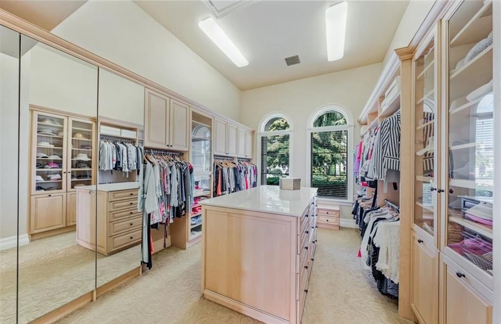Discover an exquisite 6,500 sq ft single-level home at 2116 Canna Way, Naples, FL, set on a stunning 0.78-acre lot with picturesque lake and golf course views.