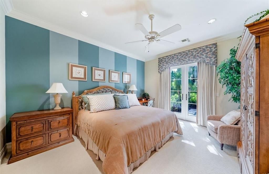 Discover an exquisite 6,500 sq ft single-level home at 2116 Canna Way, Naples, FL, set on a stunning 0.78-acre lot with picturesque lake and golf course views.