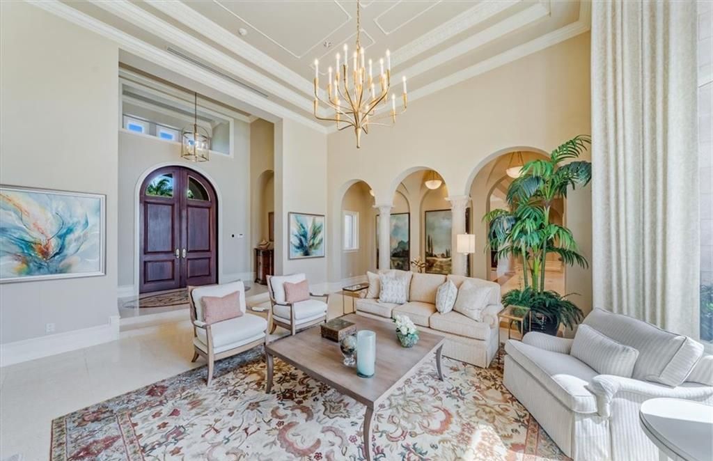 Discover an exquisite 6,500 sq ft single-level home at 2116 Canna Way, Naples, FL, set on a stunning 0.78-acre lot with picturesque lake and golf course views.
