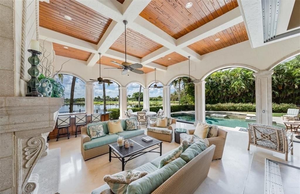 Discover an exquisite 6,500 sq ft single-level home at 2116 Canna Way, Naples, FL, set on a stunning 0.78-acre lot with picturesque lake and golf course views.