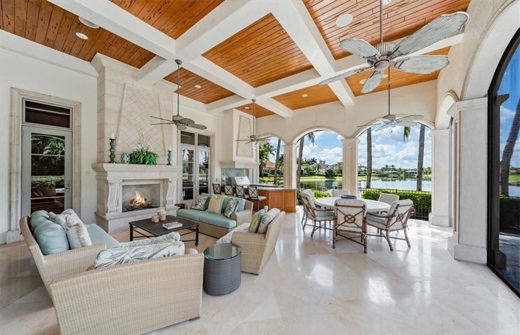 Discover an exquisite 6,500 sq ft single-level home at 2116 Canna Way, Naples, FL, set on a stunning 0.78-acre lot with picturesque lake and golf course views.