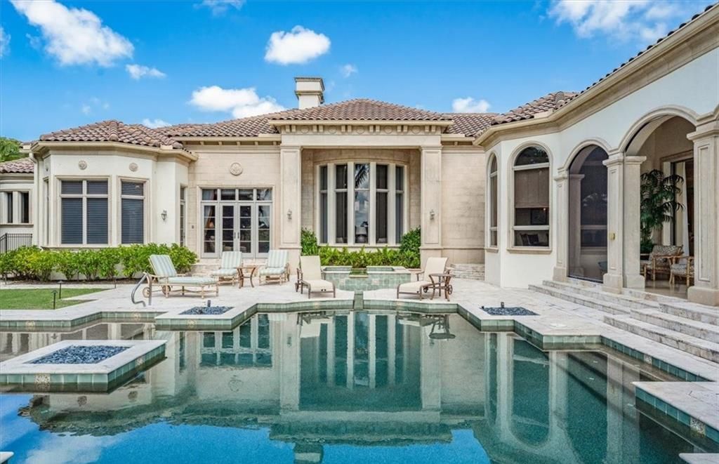 Discover an exquisite 6,500 sq ft single-level home at 2116 Canna Way, Naples, FL, set on a stunning 0.78-acre lot with picturesque lake and golf course views.