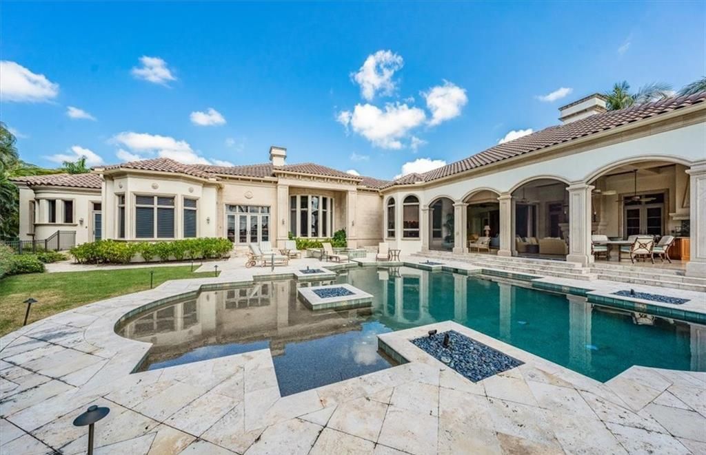 Discover an exquisite 6,500 sq ft single-level home at 2116 Canna Way, Naples, FL, set on a stunning 0.78-acre lot with picturesque lake and golf course views.