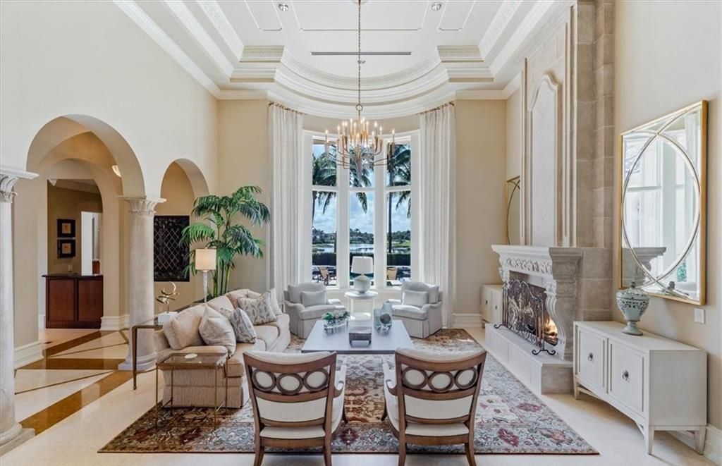 Discover an exquisite 6,500 sq ft single-level home at 2116 Canna Way, Naples, FL, set on a stunning 0.78-acre lot with picturesque lake and golf course views.