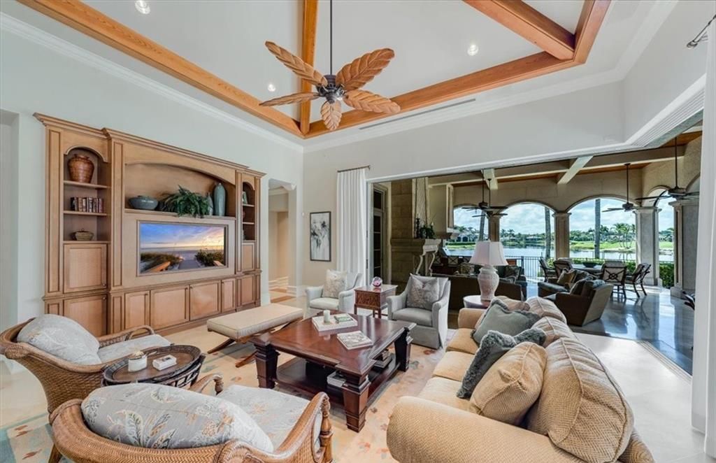 Discover an exquisite 6,500 sq ft single-level home at 2116 Canna Way, Naples, FL, set on a stunning 0.78-acre lot with picturesque lake and golf course views.