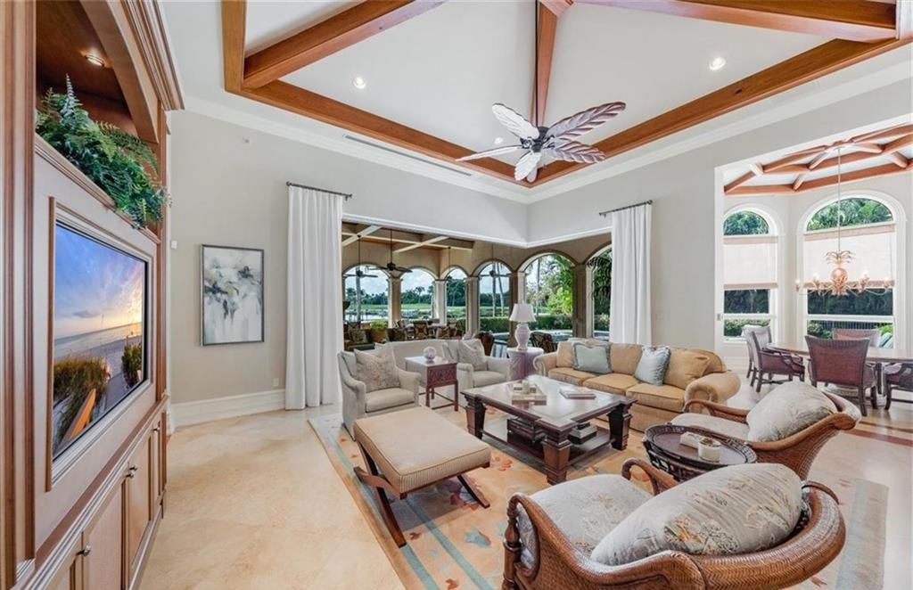 Discover an exquisite 6,500 sq ft single-level home at 2116 Canna Way, Naples, FL, set on a stunning 0.78-acre lot with picturesque lake and golf course views.