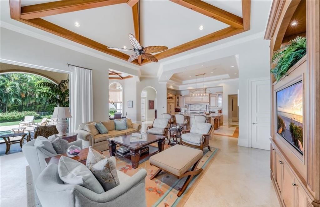 Discover an exquisite 6,500 sq ft single-level home at 2116 Canna Way, Naples, FL, set on a stunning 0.78-acre lot with picturesque lake and golf course views.