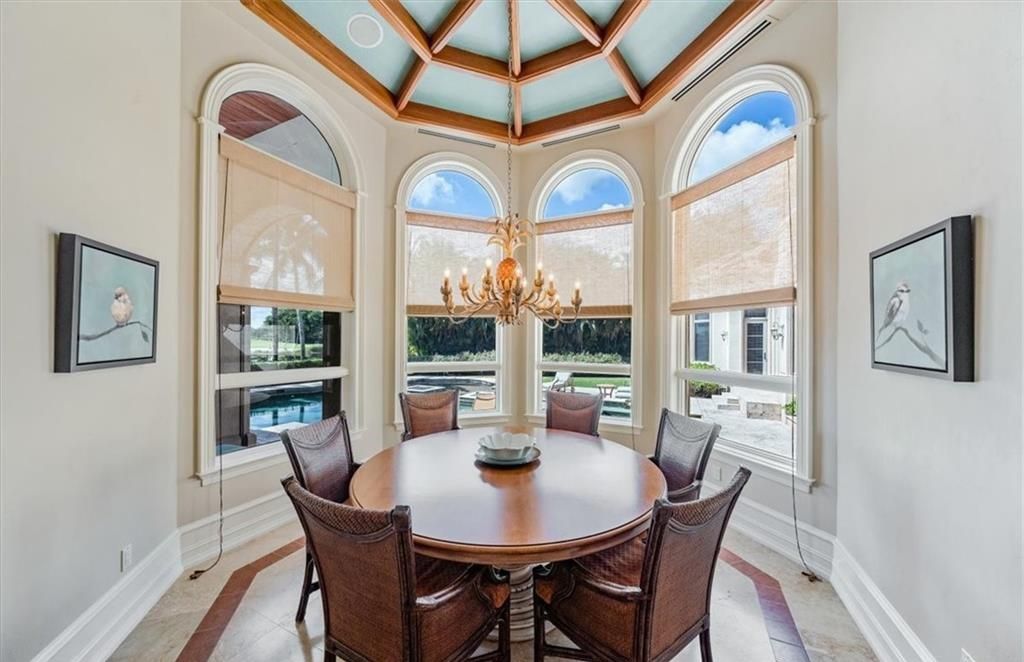 Discover an exquisite 6,500 sq ft single-level home at 2116 Canna Way, Naples, FL, set on a stunning 0.78-acre lot with picturesque lake and golf course views.