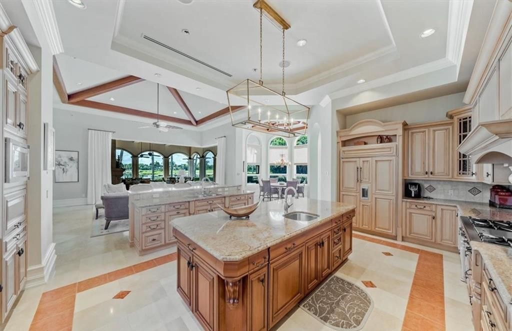 Discover an exquisite 6,500 sq ft single-level home at 2116 Canna Way, Naples, FL, set on a stunning 0.78-acre lot with picturesque lake and golf course views.