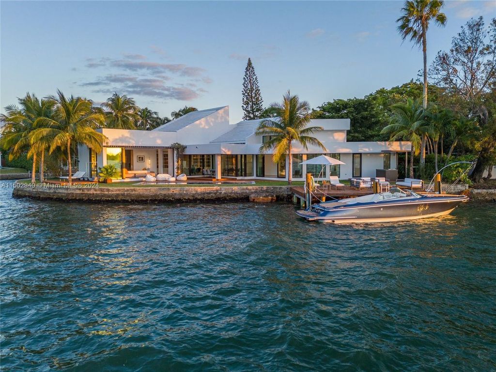 Discover unparalleled luxury in this modern masterpiece on guard-gated Biscayne Point Island. This exquisitely renovated home offers wide bay sunset views from a private peninsula with 360 feet of water frontage.