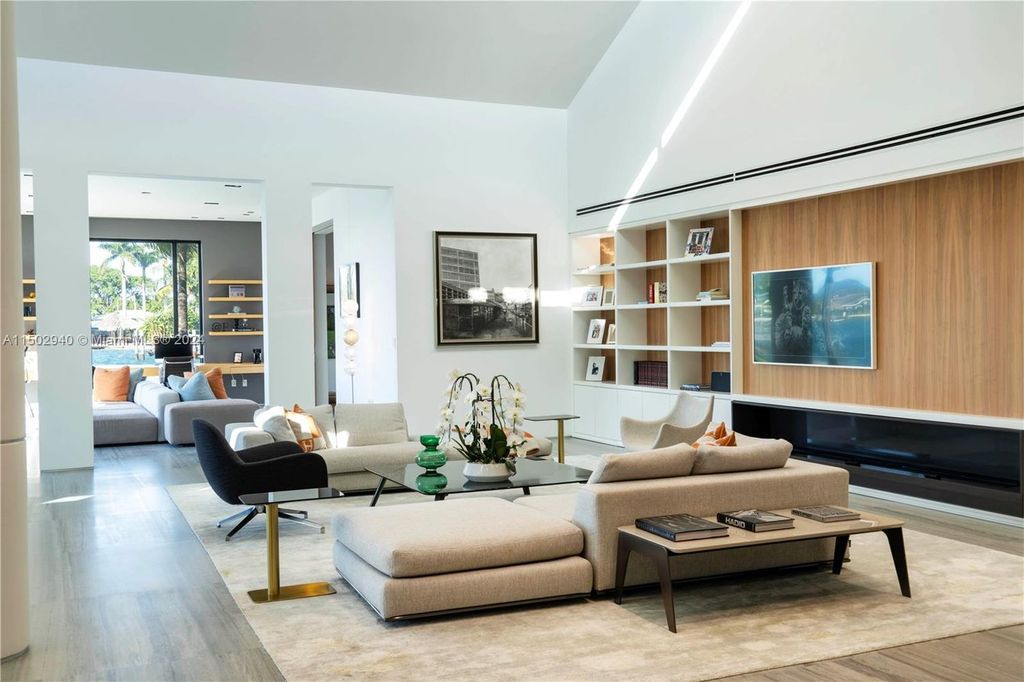 Discover unparalleled luxury in this modern masterpiece on guard-gated Biscayne Point Island. This exquisitely renovated home offers wide bay sunset views from a private peninsula with 360 feet of water frontage.
