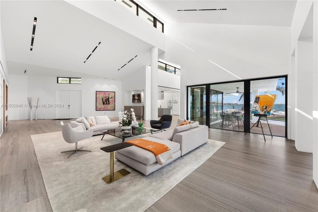 Discover unparalleled luxury in this modern masterpiece on guard-gated Biscayne Point Island. This exquisitely renovated home offers wide bay sunset views from a private peninsula with 360 feet of water frontage.