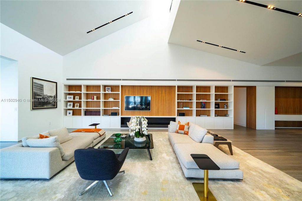 Discover unparalleled luxury in this modern masterpiece on guard-gated Biscayne Point Island. This exquisitely renovated home offers wide bay sunset views from a private peninsula with 360 feet of water frontage.