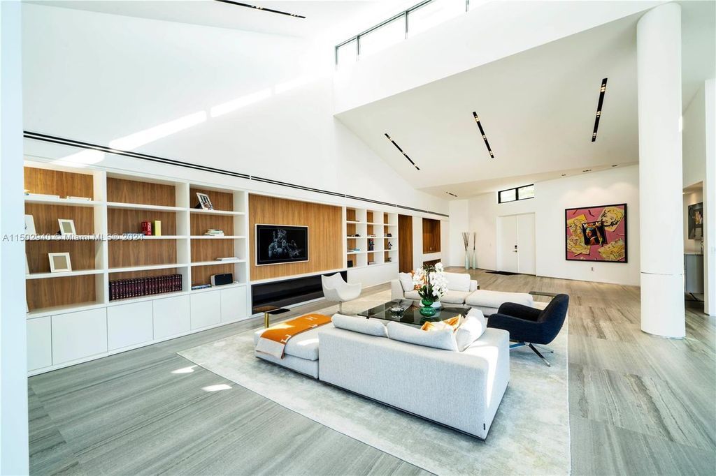 Discover unparalleled luxury in this modern masterpiece on guard-gated Biscayne Point Island. This exquisitely renovated home offers wide bay sunset views from a private peninsula with 360 feet of water frontage.