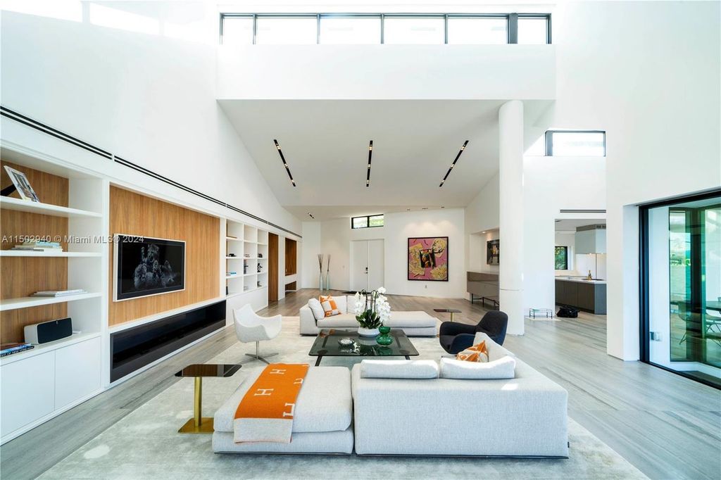 Discover unparalleled luxury in this modern masterpiece on guard-gated Biscayne Point Island. This exquisitely renovated home offers wide bay sunset views from a private peninsula with 360 feet of water frontage.