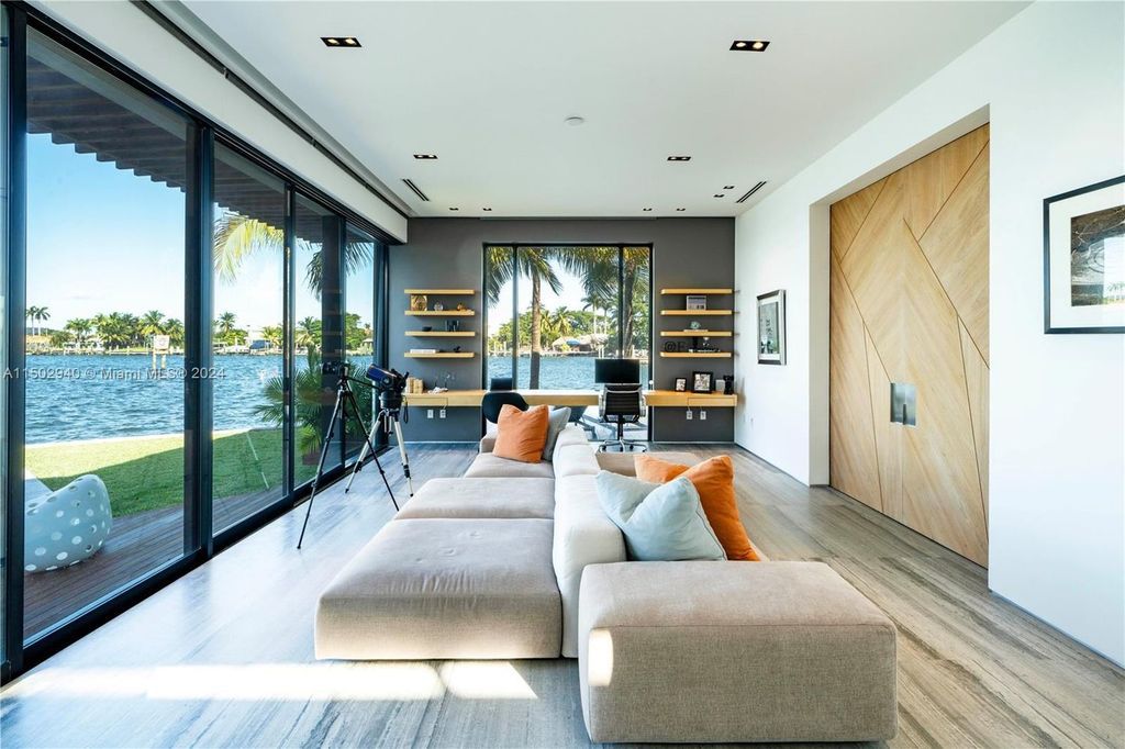 Discover unparalleled luxury in this modern masterpiece on guard-gated Biscayne Point Island. This exquisitely renovated home offers wide bay sunset views from a private peninsula with 360 feet of water frontage.