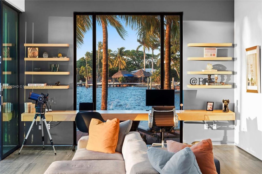 Discover unparalleled luxury in this modern masterpiece on guard-gated Biscayne Point Island. This exquisitely renovated home offers wide bay sunset views from a private peninsula with 360 feet of water frontage.