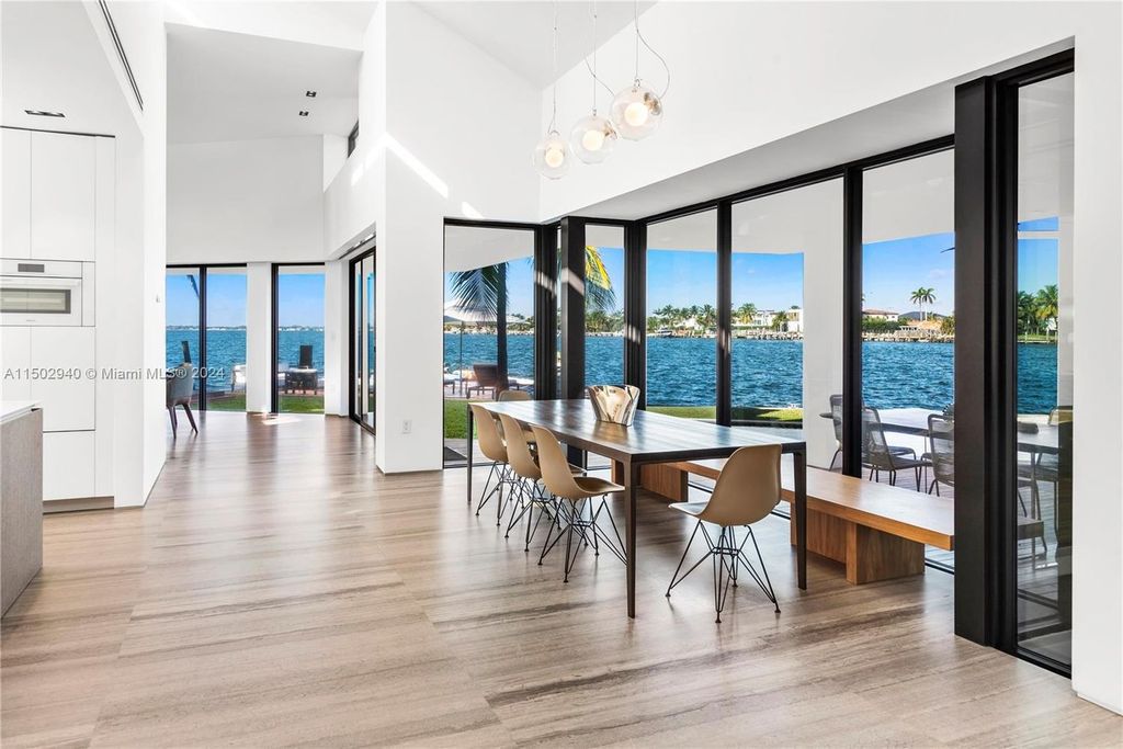 Discover unparalleled luxury in this modern masterpiece on guard-gated Biscayne Point Island. This exquisitely renovated home offers wide bay sunset views from a private peninsula with 360 feet of water frontage.