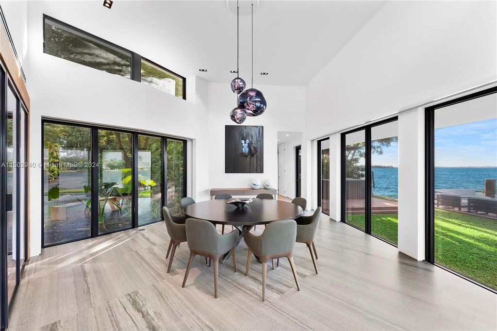 Discover unparalleled luxury in this modern masterpiece on guard-gated Biscayne Point Island. This exquisitely renovated home offers wide bay sunset views from a private peninsula with 360 feet of water frontage.