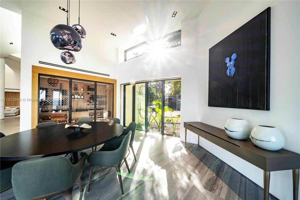 Discover unparalleled luxury in this modern masterpiece on guard-gated Biscayne Point Island. This exquisitely renovated home offers wide bay sunset views from a private peninsula with 360 feet of water frontage.