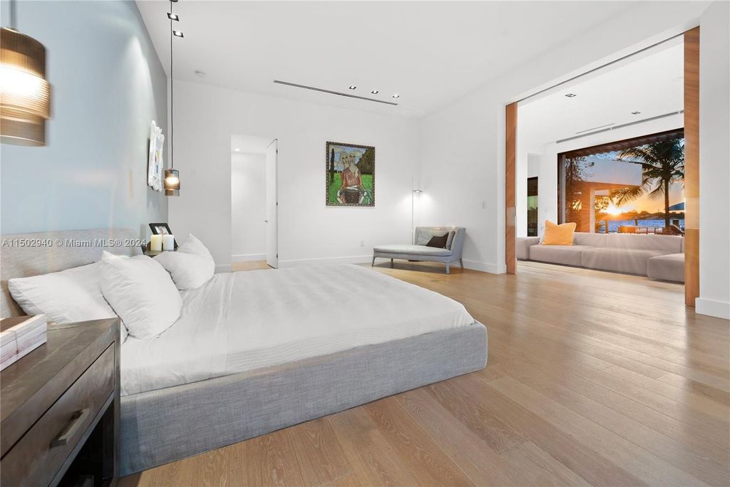 Discover unparalleled luxury in this modern masterpiece on guard-gated Biscayne Point Island. This exquisitely renovated home offers wide bay sunset views from a private peninsula with 360 feet of water frontage.