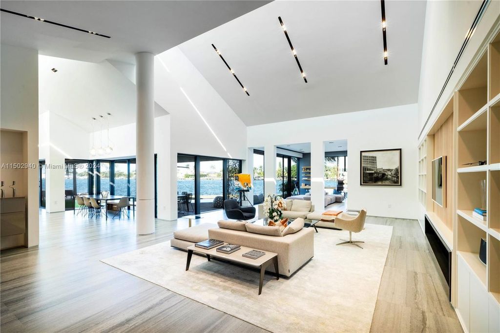 Discover unparalleled luxury in this modern masterpiece on guard-gated Biscayne Point Island. This exquisitely renovated home offers wide bay sunset views from a private peninsula with 360 feet of water frontage.