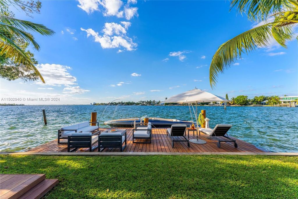Discover unparalleled luxury in this modern masterpiece on guard-gated Biscayne Point Island. This exquisitely renovated home offers wide bay sunset views from a private peninsula with 360 feet of water frontage.