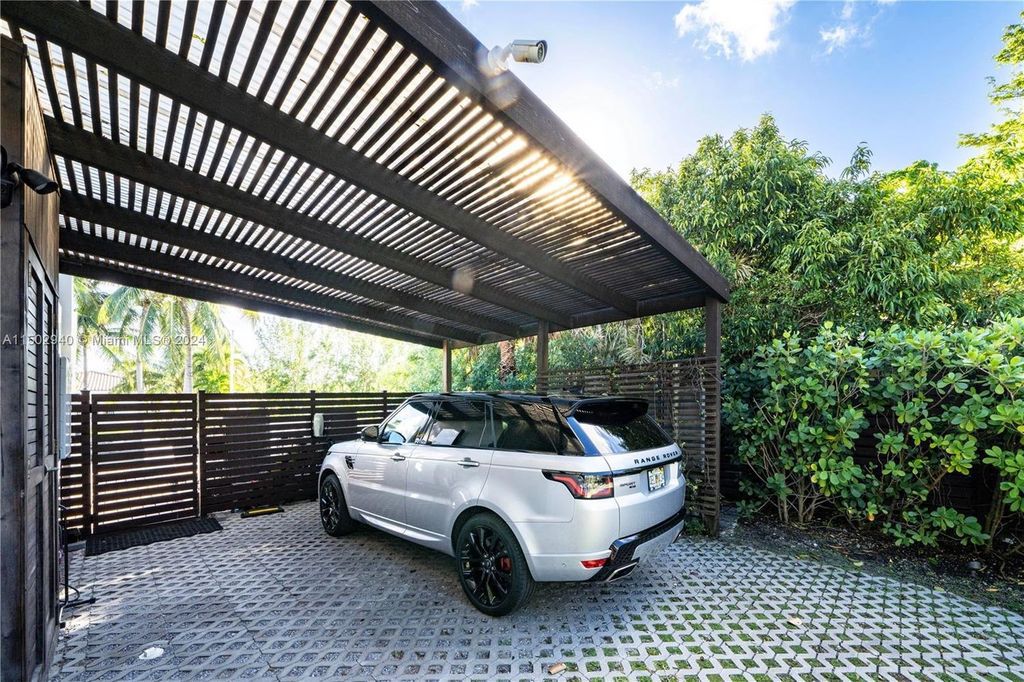 Discover unparalleled luxury in this modern masterpiece on guard-gated Biscayne Point Island. This exquisitely renovated home offers wide bay sunset views from a private peninsula with 360 feet of water frontage.