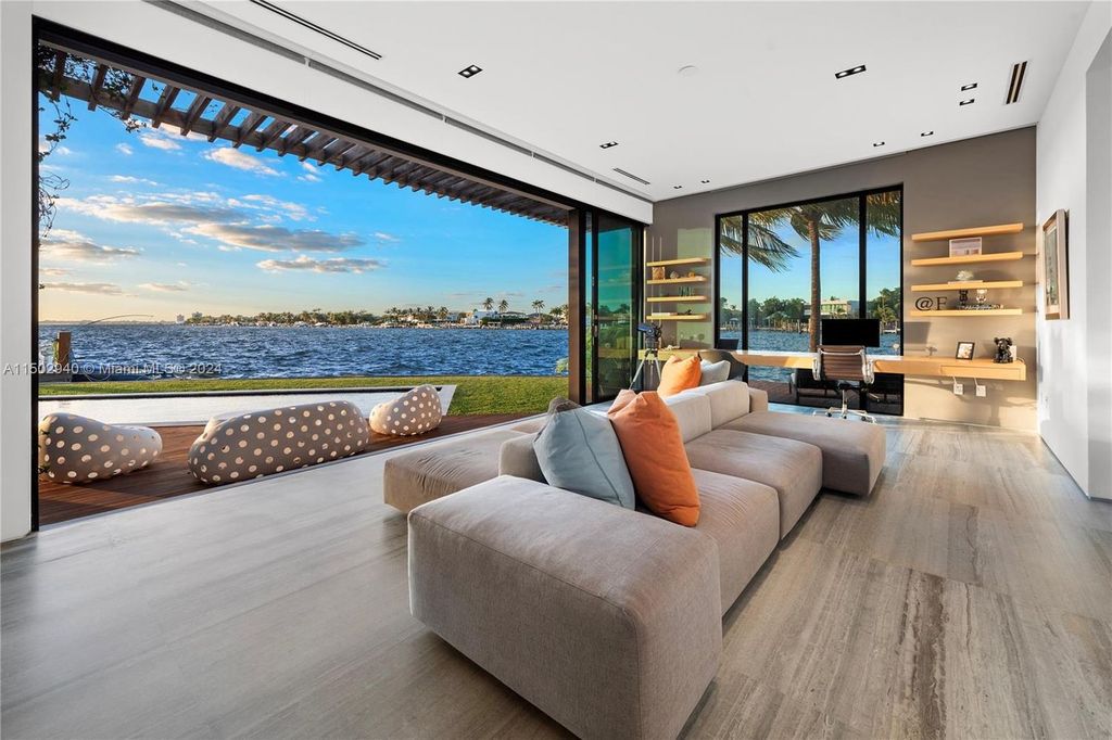 Discover unparalleled luxury in this modern masterpiece on guard-gated Biscayne Point Island. This exquisitely renovated home offers wide bay sunset views from a private peninsula with 360 feet of water frontage.