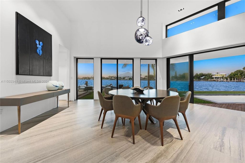 Discover unparalleled luxury in this modern masterpiece on guard-gated Biscayne Point Island. This exquisitely renovated home offers wide bay sunset views from a private peninsula with 360 feet of water frontage.