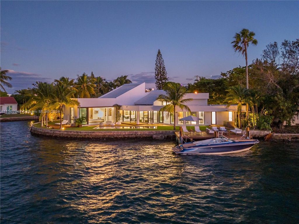 Discover unparalleled luxury in this modern masterpiece on guard-gated Biscayne Point Island. This exquisitely renovated home offers wide bay sunset views from a private peninsula with 360 feet of water frontage.