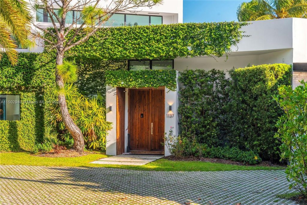 Discover unparalleled luxury in this modern masterpiece on guard-gated Biscayne Point Island. This exquisitely renovated home offers wide bay sunset views from a private peninsula with 360 feet of water frontage.