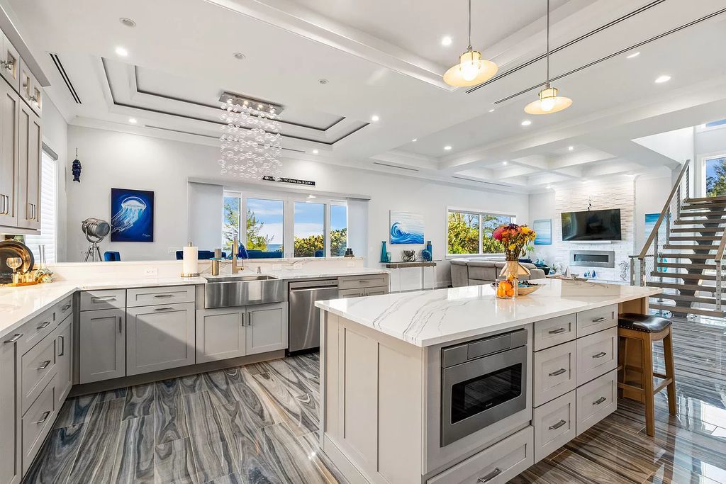 With dual A/C garages and durable coastal design elements throughout, including marine-grade paint and impact glass, this 3-bedroom, 5-bathroom home on a 0.65-acre lot at 3800 Anacostia Pl, Fort Pierce, FL 34949, built in 2019, presents an exceptional opportunity to embrace the coastal lifestyle in utmost comfort and elegance.