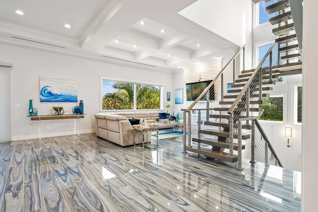 With dual A/C garages and durable coastal design elements throughout, including marine-grade paint and impact glass, this 3-bedroom, 5-bathroom home on a 0.65-acre lot at 3800 Anacostia Pl, Fort Pierce, FL 34949, built in 2019, presents an exceptional opportunity to embrace the coastal lifestyle in utmost comfort and elegance.