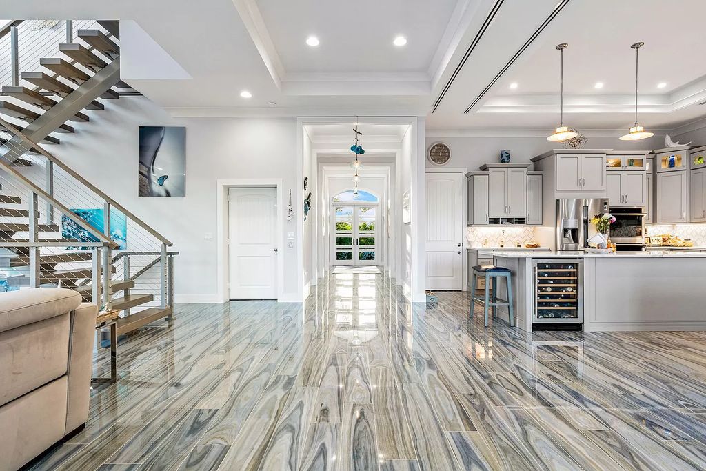 With dual A/C garages and durable coastal design elements throughout, including marine-grade paint and impact glass, this 3-bedroom, 5-bathroom home on a 0.65-acre lot at 3800 Anacostia Pl, Fort Pierce, FL 34949, built in 2019, presents an exceptional opportunity to embrace the coastal lifestyle in utmost comfort and elegance.