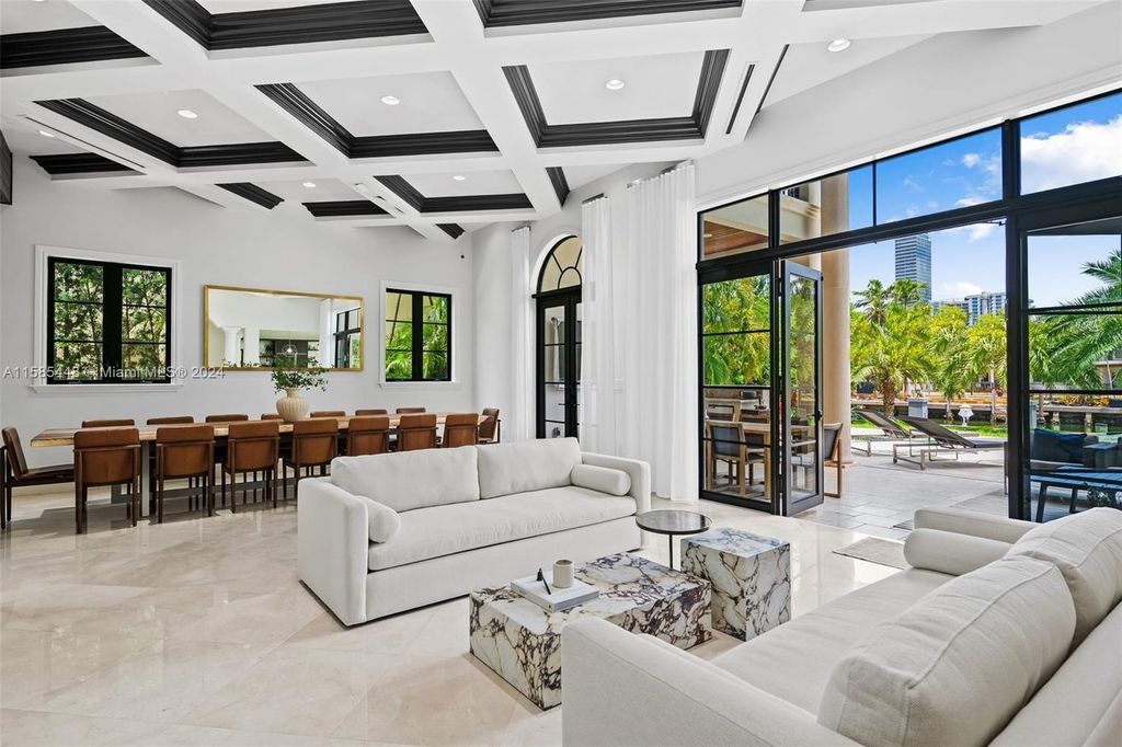 Located in the prestigious gated community of Golden Isles, this exquisite waterfront home at 631 Hibiscus Dr, Hallandale Beach, boasts six bedrooms and seven and a half opulent bathrooms within its 5,829 square feet of refined living space