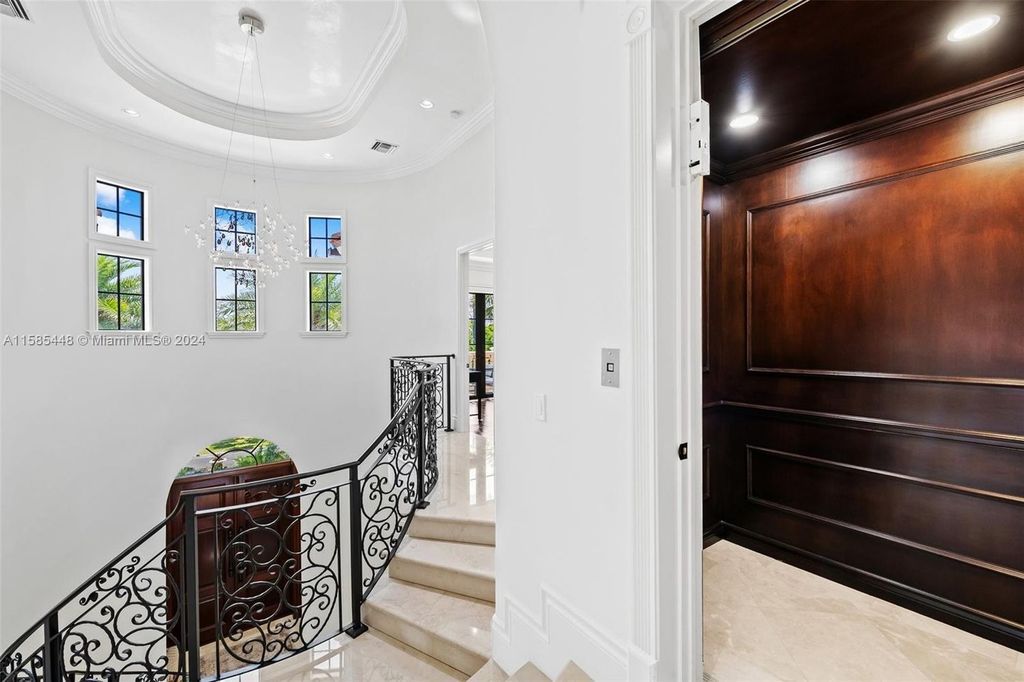 Located in the prestigious gated community of Golden Isles, this exquisite waterfront home at 631 Hibiscus Dr, Hallandale Beach, boasts six bedrooms and seven and a half opulent bathrooms within its 5,829 square feet of refined living space