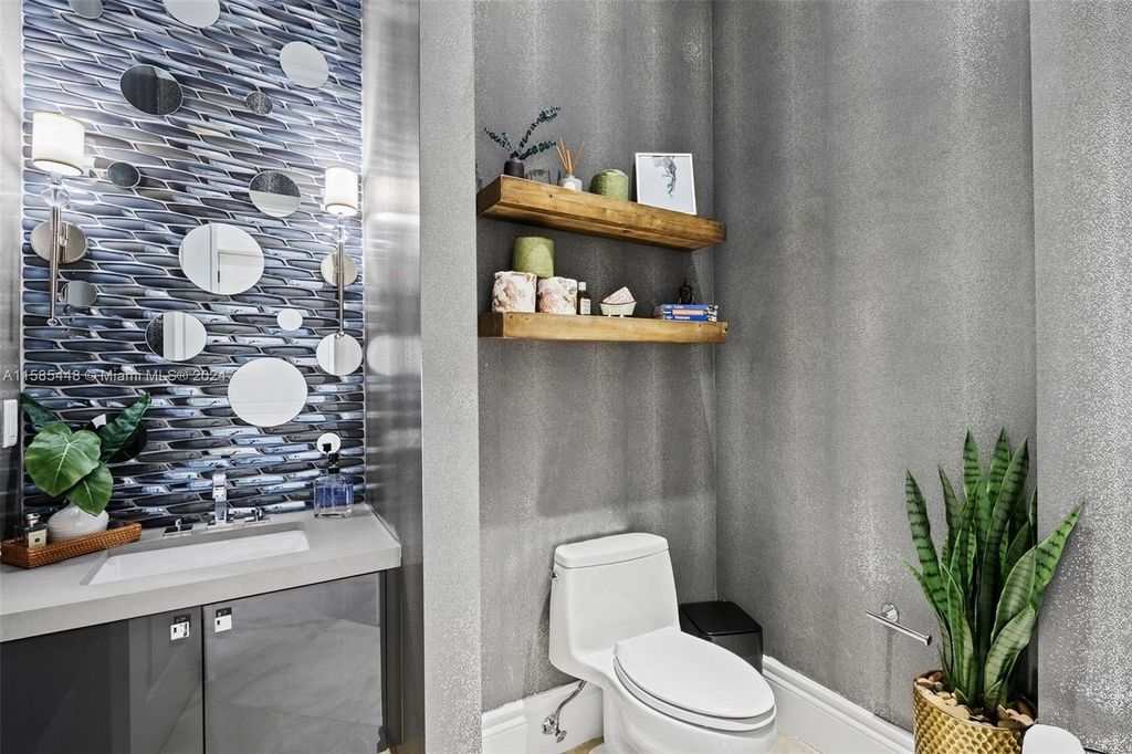 Located in the prestigious gated community of Golden Isles, this exquisite waterfront home at 631 Hibiscus Dr, Hallandale Beach, boasts six bedrooms and seven and a half opulent bathrooms within its 5,829 square feet of refined living space