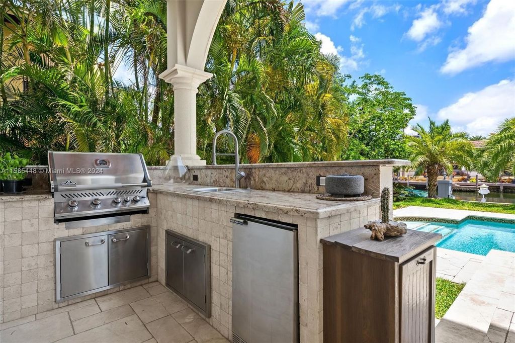 Located in the prestigious gated community of Golden Isles, this exquisite waterfront home at 631 Hibiscus Dr, Hallandale Beach, boasts six bedrooms and seven and a half opulent bathrooms within its 5,829 square feet of refined living space