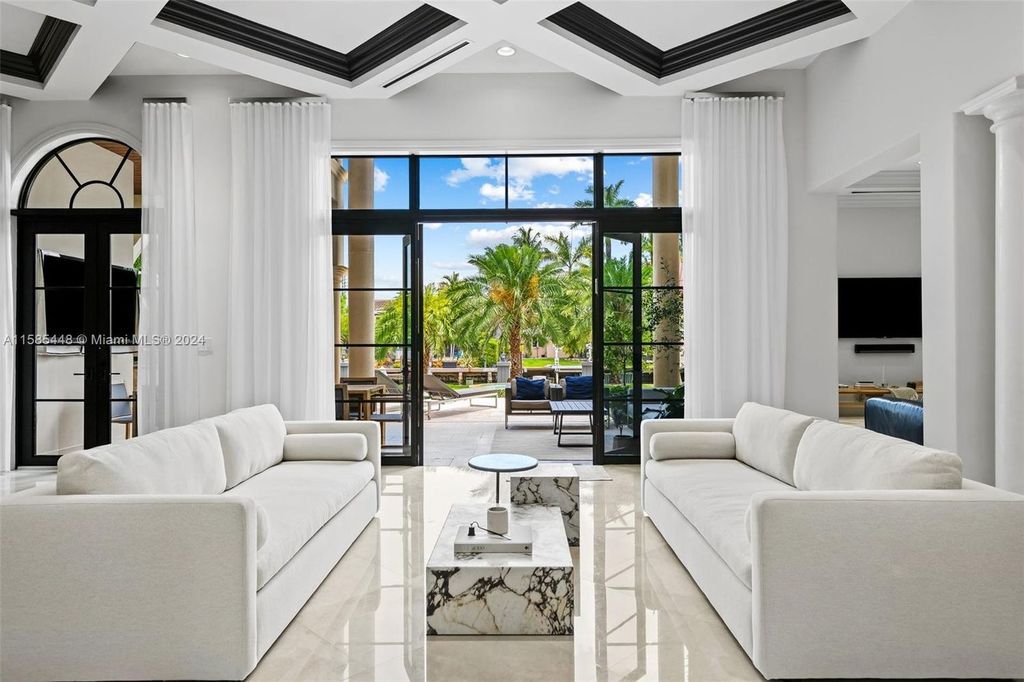 Located in the prestigious gated community of Golden Isles, this exquisite waterfront home at 631 Hibiscus Dr, Hallandale Beach, boasts six bedrooms and seven and a half opulent bathrooms within its 5,829 square feet of refined living space