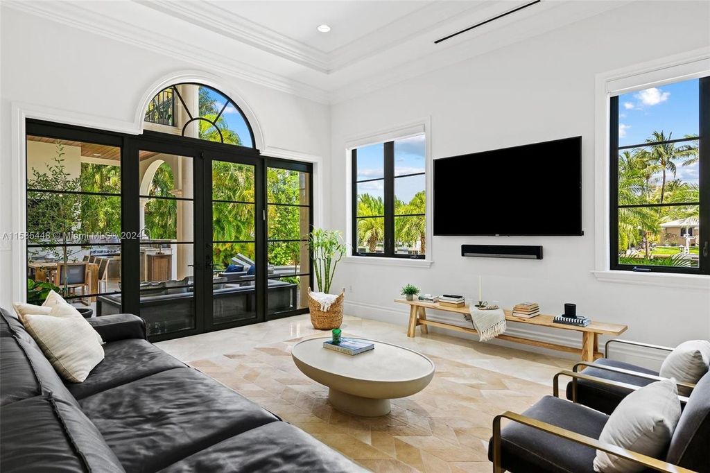 Located in the prestigious gated community of Golden Isles, this exquisite waterfront home at 631 Hibiscus Dr, Hallandale Beach, boasts six bedrooms and seven and a half opulent bathrooms within its 5,829 square feet of refined living space
