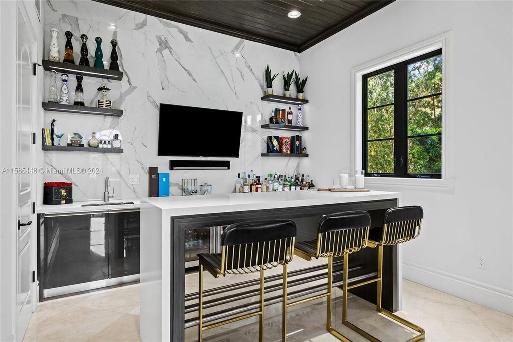 Located in the prestigious gated community of Golden Isles, this exquisite waterfront home at 631 Hibiscus Dr, Hallandale Beach, boasts six bedrooms and seven and a half opulent bathrooms within its 5,829 square feet of refined living space
