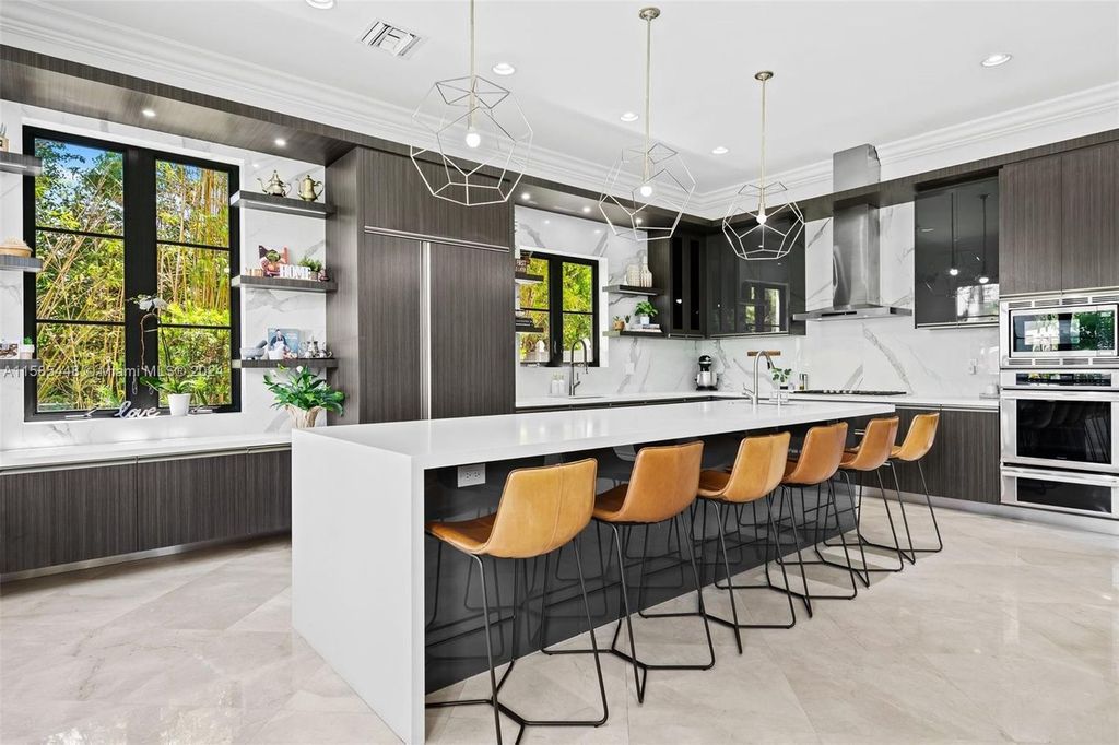 Located in the prestigious gated community of Golden Isles, this exquisite waterfront home at 631 Hibiscus Dr, Hallandale Beach, boasts six bedrooms and seven and a half opulent bathrooms within its 5,829 square feet of refined living space