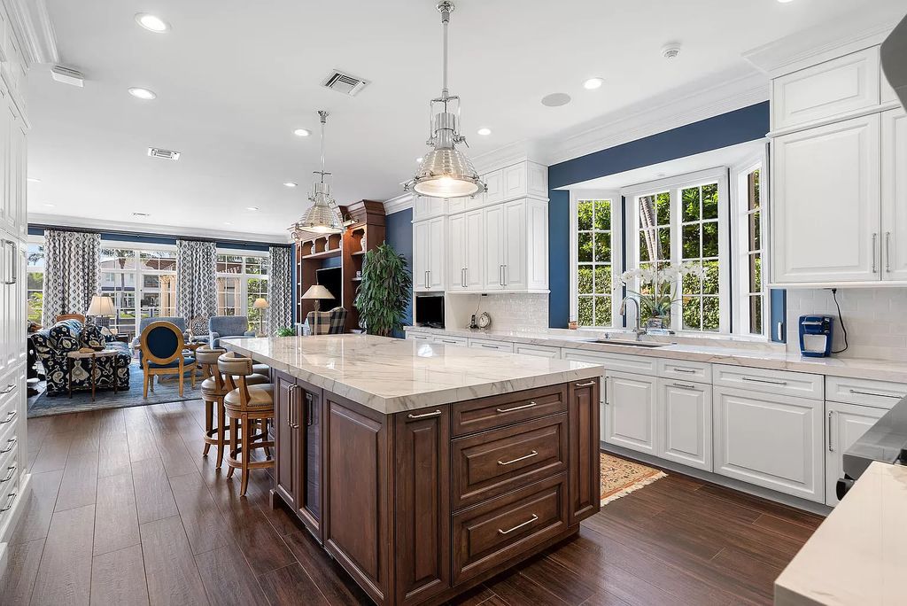 Discover unparalleled luxury at 336 E Coconut Palm Road in the prestigious Royal Palm Yacht & Country Club.